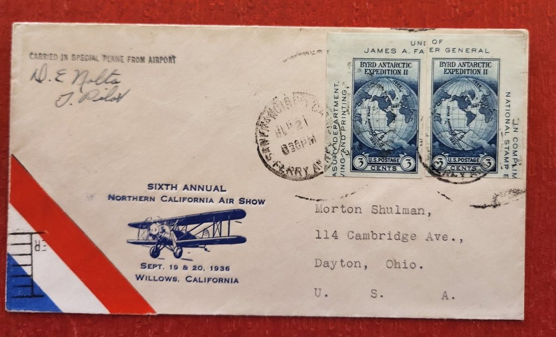 An envelope with a blue biplane and the words Sixth Annual Northern California Air Show, Sept. 19 and 20, 1936, Willows, California, two Byrd Antarctic Expedition stamps, and a handwritten signature reading D. E. Nolta, Pilot
